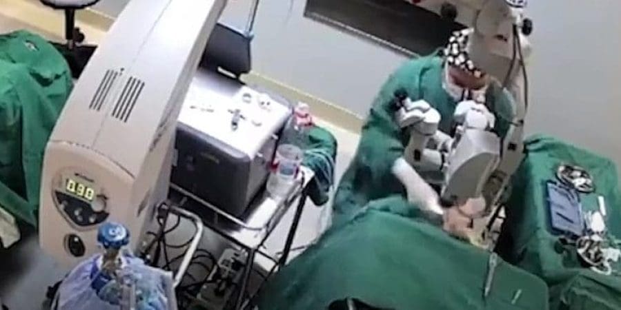 لقطة من فيديو الواقعة يظهر جراح صيني وهو يضرب مريضة خلال عملية في عينيها